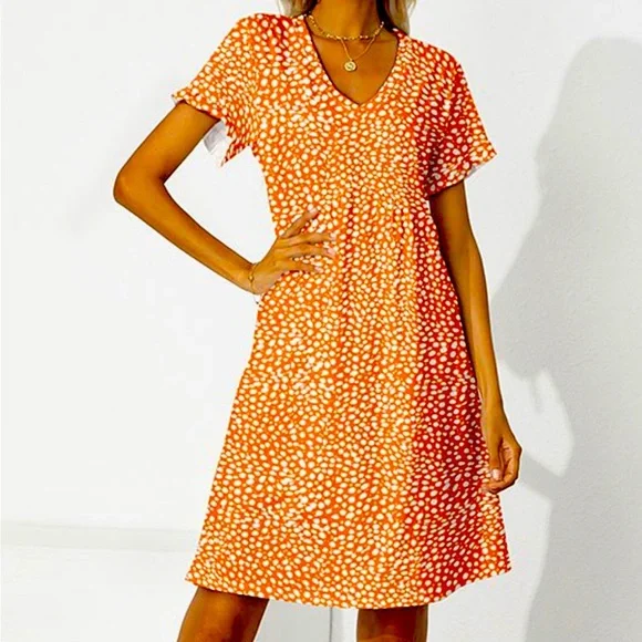 Ruffled v-necked flowing dress with gathered waist.